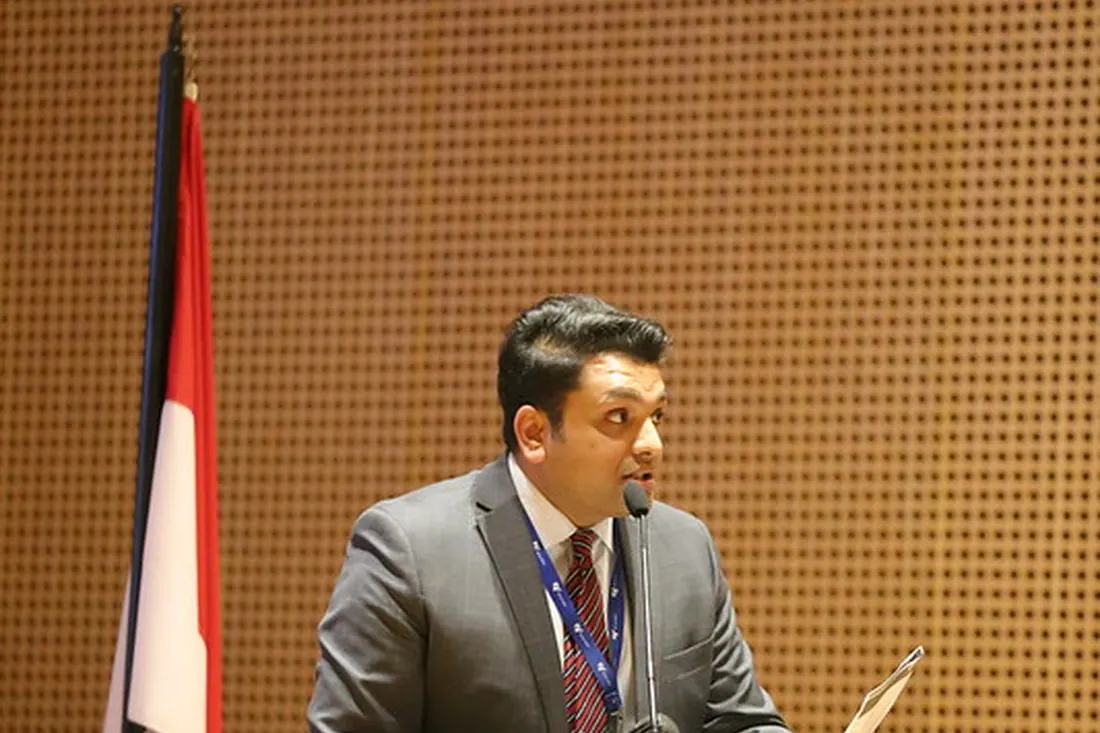 Aqeeb Akram speaking from a lectern at the Australian Embassy in Jakarta.