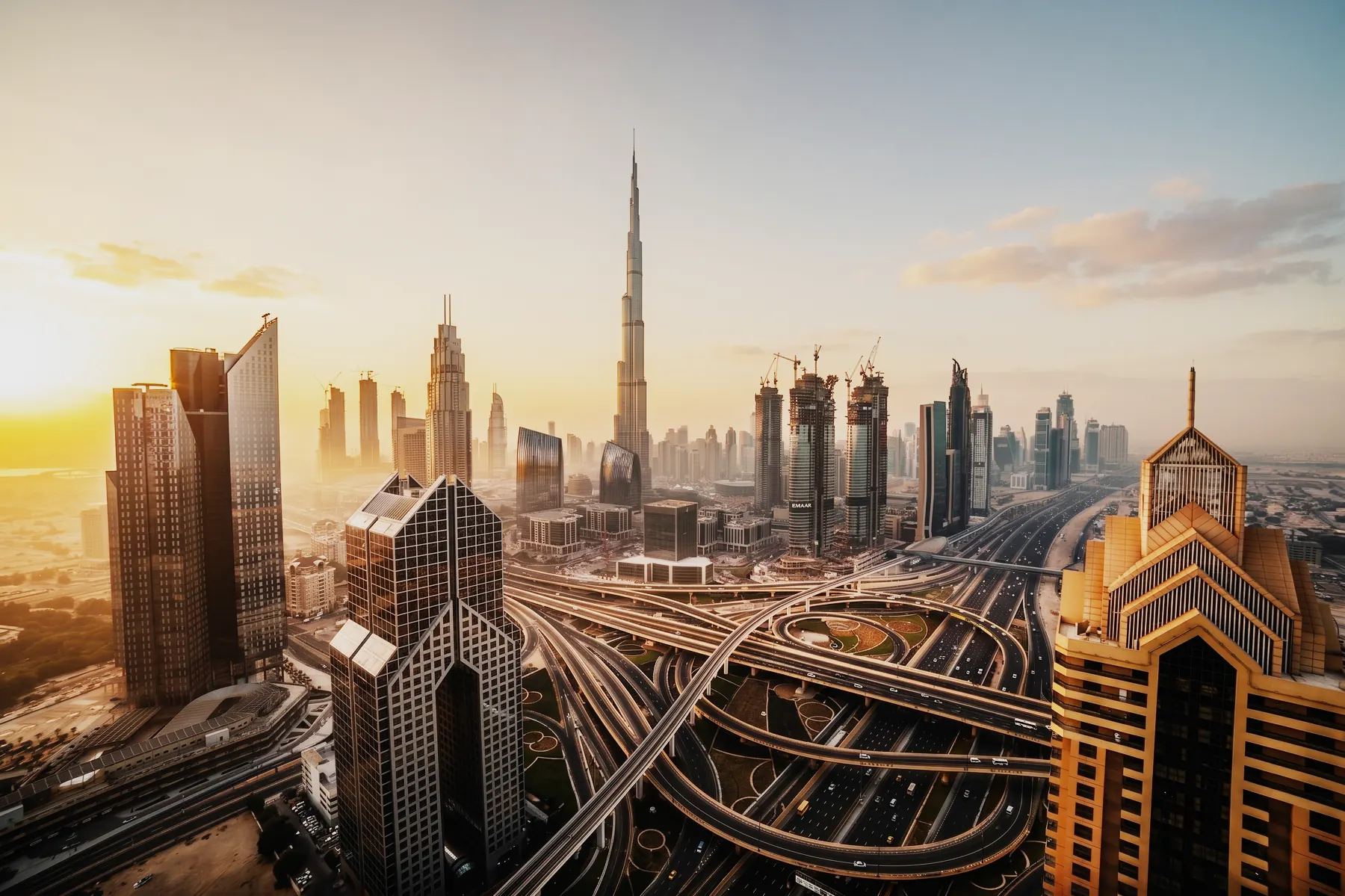 Downtown Dubai at sunrise, the Burj Khalifa above Sheikh Zayed Road and its interchange.