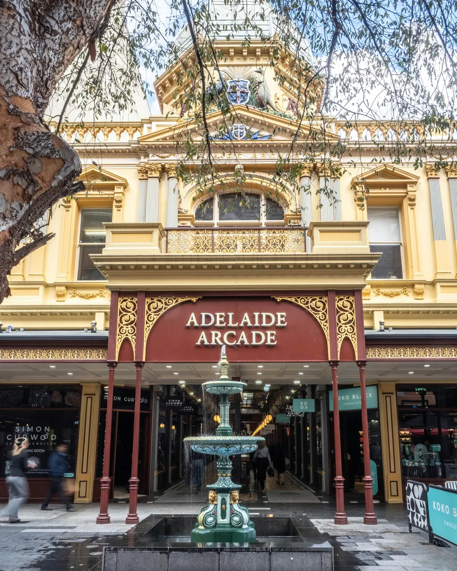 The entrance to Adelaide Arcade on Rundle Mall, with a fountain in front.