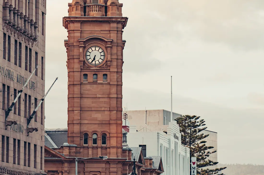 A historic clock tower on a street in central Hobart.
