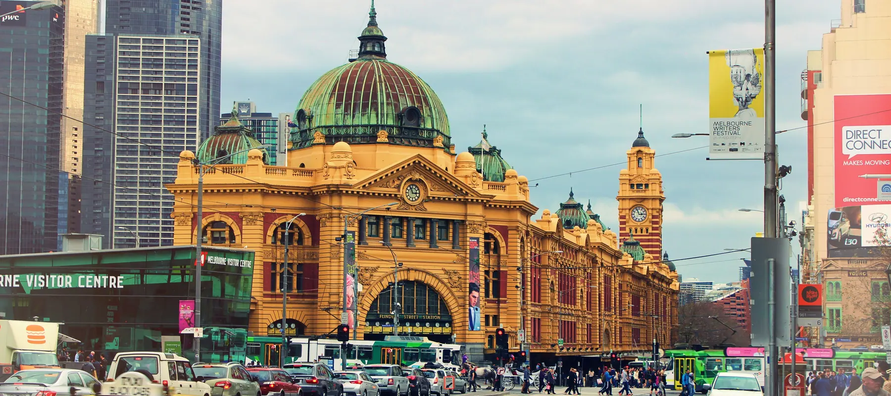 Flinders Street Station in central Melbourne, with trams and traffic outside.