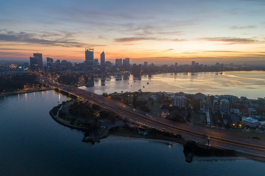 Perth and the Swan River from the air at dusk, with the Narrows Bridge.