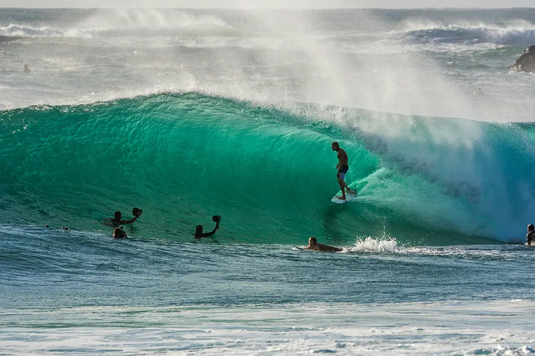 A surfer riding inside a breaking wave off the New South Wales coast.